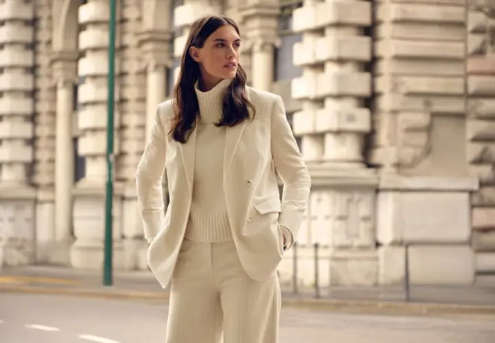 Elegantes cremefarbenes Cord-Outfit: Was zieht man zur Einschulung an als Gast? Ein schicker Hosenanzug mit Rollkragenpullover.