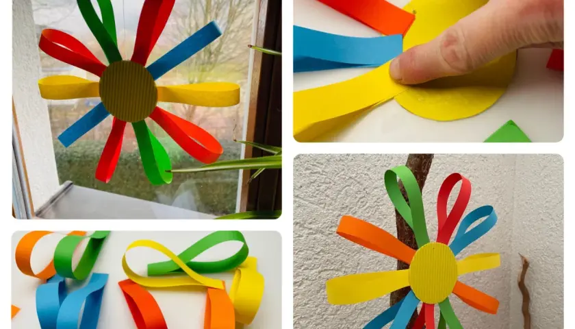 Bunte Papierblumen basteln Kinder leicht. Aus Papierstreifen entstehen Blumen, die man aufhängen kann.