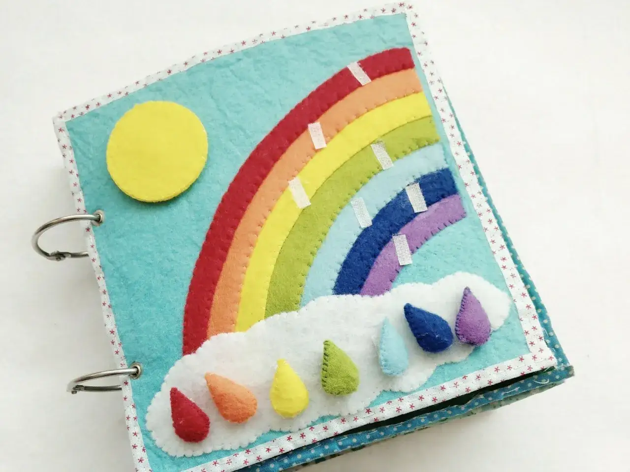 Ein buntes Filzbuch mit Sonne, Regenbogen und Regentropfen. Dieses liebevolle ich buch ist perfekt f&uuml;r kleine Entdecker.